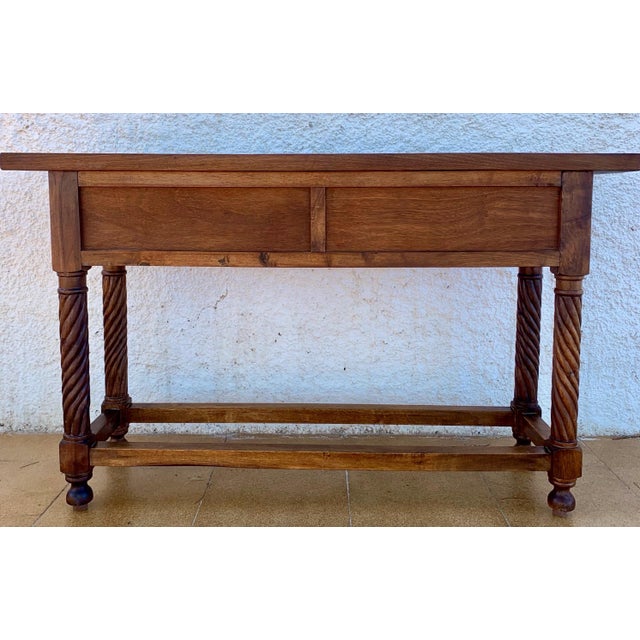 Spanish Renaissance Revival console table crafted in solid wood, dating from the 20th century. The front features two...