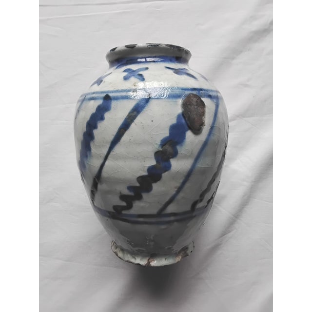 19th Century Earthenware Vase. Complete with white underglaze and painted geometric shapes. The glaze has a crackle...