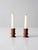 A pair of vintage turned wood candlestick holders dating to the early 20th century, exemplifying classic American Colonial...