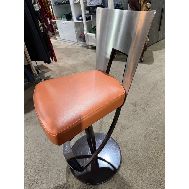 Sleek, sculptural, and unmistakably modern, this “Regal” bar stool by Elite Modern delivers a refined blend of...
