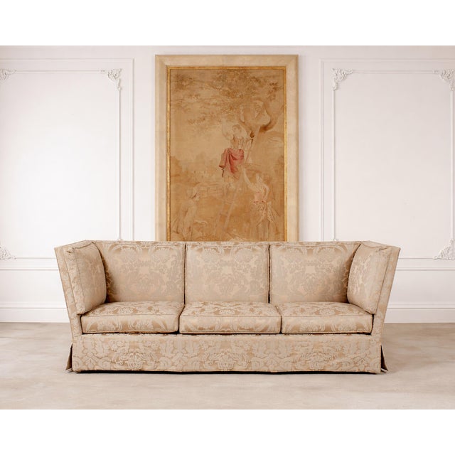 An elegant shelter-arm form sofa in a Fortuny attributed champagne and ivory damask upholstery designed by John Hutton for...