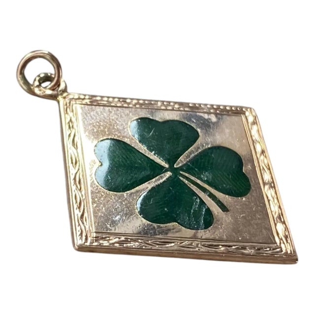 Antique four leaf clover charm pendant crafted in 14K rose gold, featuring a diamond shape with hand engraved borders and...