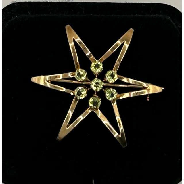 This is part of Chairish’s Fine Jewelry assortment. 14k Yellow Gold & 7 Peridot Flower Shaped Brooch/Pendant. Weight of...