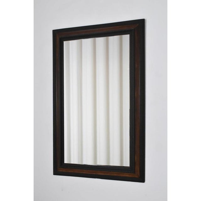Carved ebonised wood mirror and trompe l'oeil turshell, XIXth c. Height: 158 cm - 62.2 in Length: 98 cm - 38.58 in Width:...