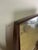 Mirror with a finely curved wooden frame and thick glass shelf, Italian-made in the 1950s. The mirror has been carefully...
