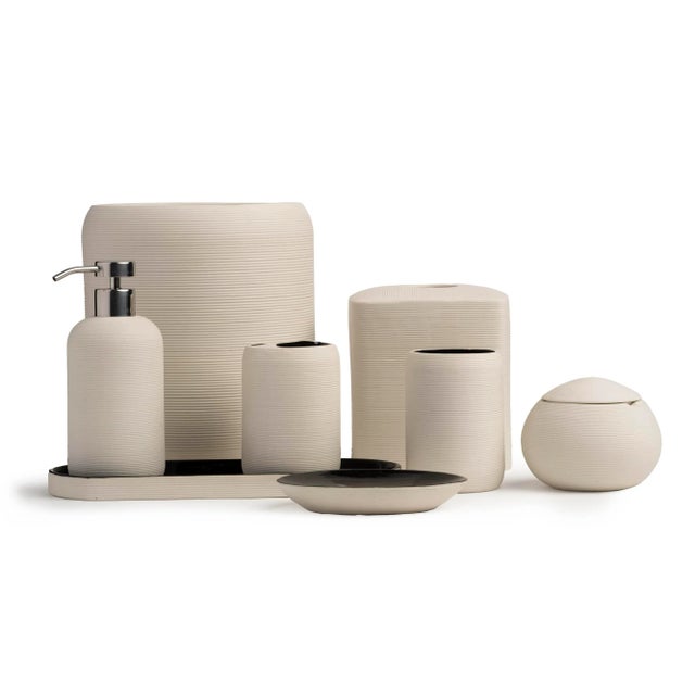Crafted from porcelain, the Fillmore bath accessories feature a ribbed texture. Ivory on the outside and black on the...