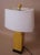 Yellow porcelain square lamp on bronze base with matching yellow round ceramic finial. Includes rectangular white linen...