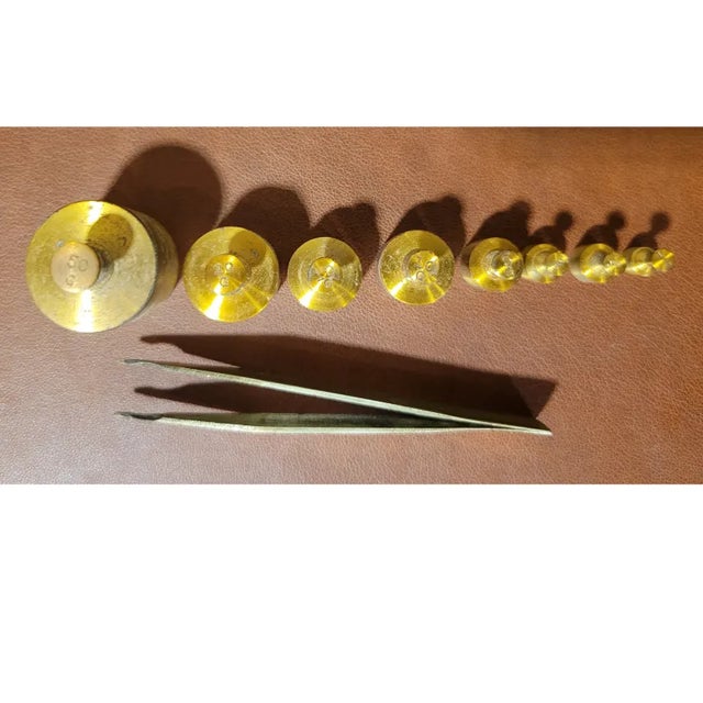 A complete 8-piece set of solid brass jeweler weights. The set comes in its original fitted hinged oak box, adding to its...