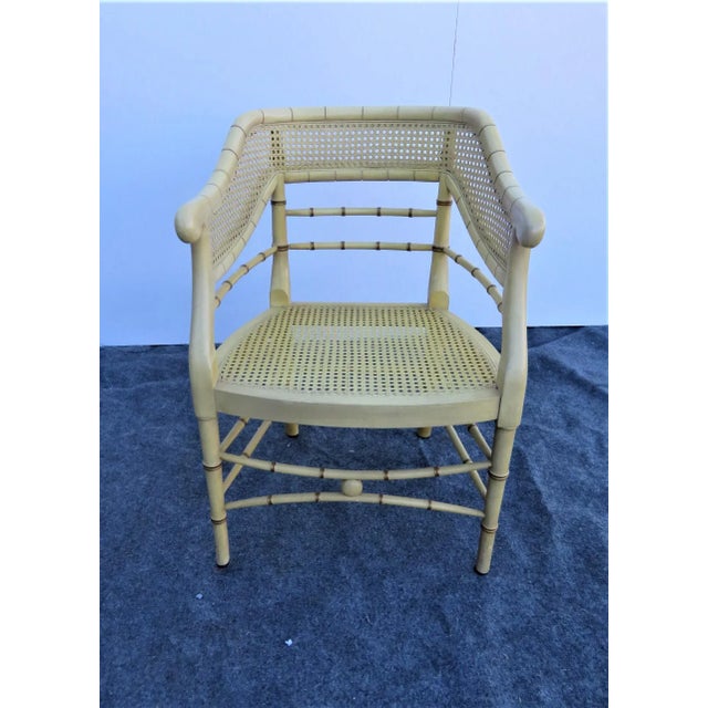 Regency Style Faux bamboo side chair, light creamy yellow painted finish with gold accents, caned panel on back, loose...
