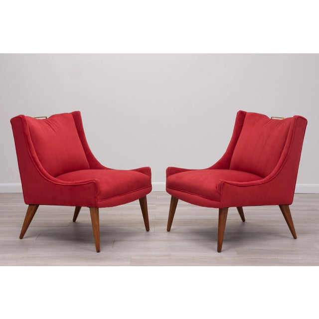 Elegant pair of Harvey Probber slipper lounge chairs. Freshly upholstered in a salmon colored velvet. Brass handle detail...