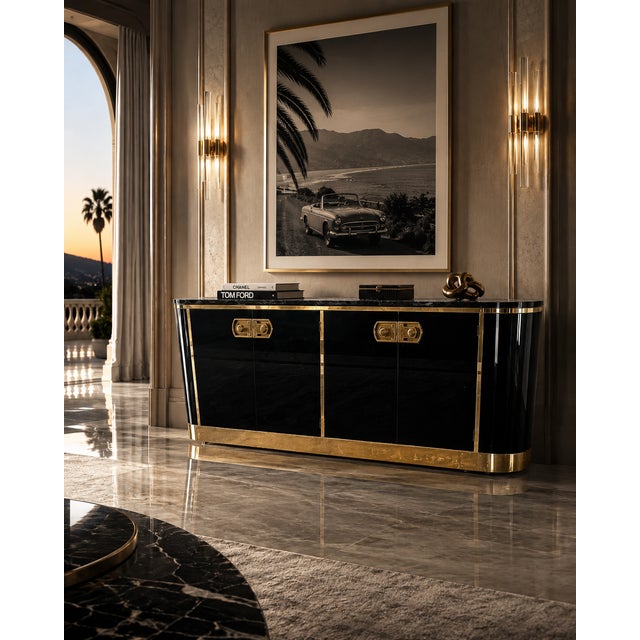 A sculptural and richly appointed Mastercraft credenza featuring their iconic combination of high-gloss black lacquer and...