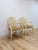 This pair of vintage chairs by Fairfield showcases classic French Provincial styling, featuring cane back detailing paired...