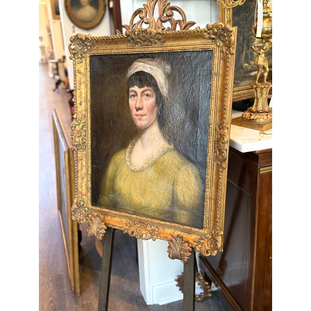 Atmospheric English School portrait of a young woman dating to circa 1820, painted in oil on canvas. The sitter is...