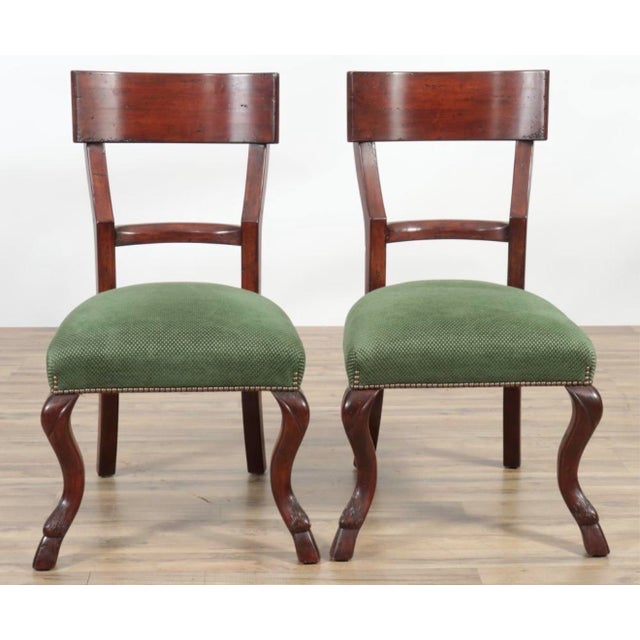 Set of Eight Regency Style Mahogany Dining Chairs, two armchairs, upholstered in green woven fabric. Legs and feet looks...