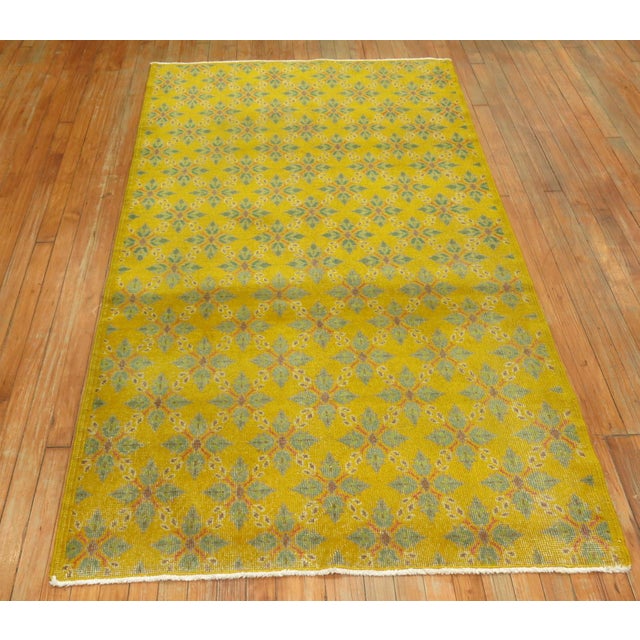 Turkish Anatolian rug with yellow field, accents in pink and green.