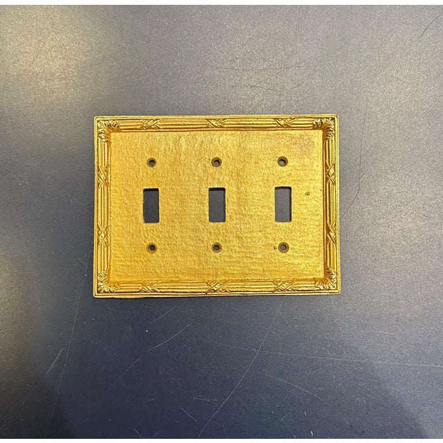 Set of 7 Sherle Wagner Ribbon and Reed Triple Switch Plates. Burnished Gold Finish.