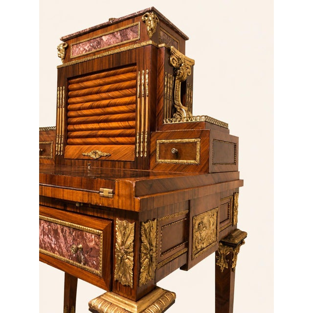 An exceptional french bonheur-du-jour style desk with a roll-up shutter, in the louis xv style, made during the reign of...