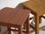 A pair of antique bedside tables in pine wood, with a square top and four tapered legs tied by box stretchers. They...