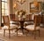 Elegant set of four vintage French Louis XVI-style dining chairs featuring gracefully curved cane backs, carved floral...