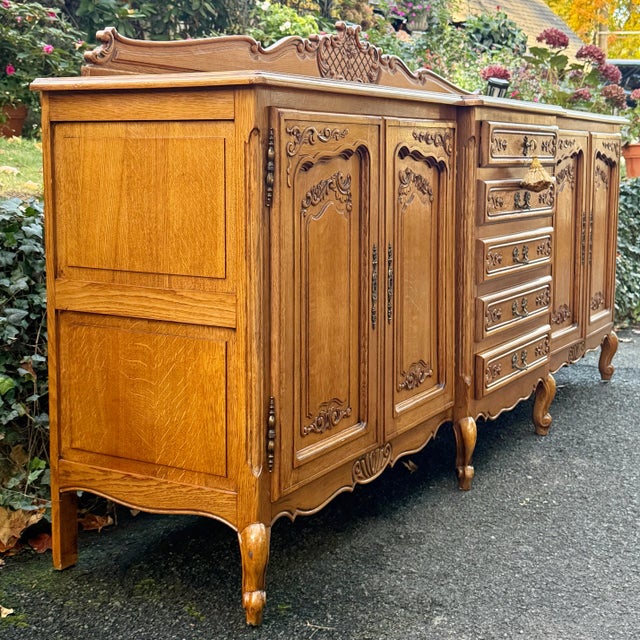 Gorgeous French sideboard makes quite a statement with its 92” frame. Striking tiger oak grain front and top, four raised...
