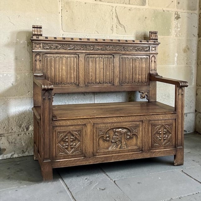 Antique Gothic Revival Carved Hall Bench was rendered from solid oak, and features timeless hand-carved motifs for your...