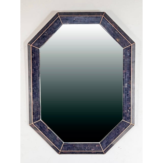 A tessellated horn tortoise shell wall mirror by Maitland Smith, circa 1980s. Beveled mirror glass; inlaid brass accent,...