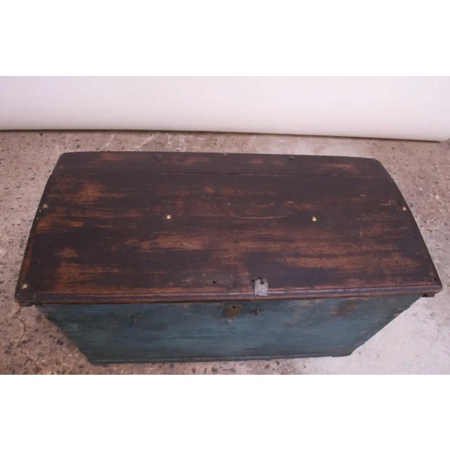 Primitive trunk / chest composed of a hinged wood plank top and painted wooden frame with brass and steel embellishments...