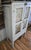 This amazing original white painted pie safe cupboard is in great condition with four punched tins in double doors.The...