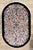 Hand-knotted wool rug measuring 3'1" x 4'11", featuring an oval format with an allover floral pattern on an ivory field...