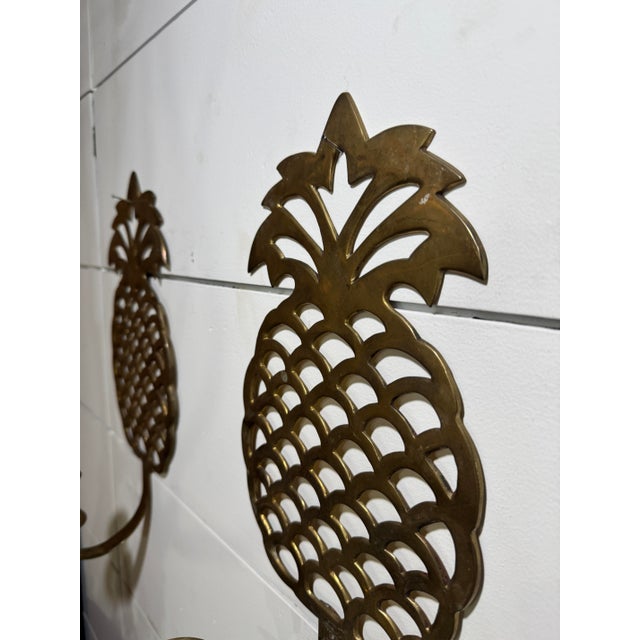 Add a touch of timeless elegance to your home with this exquisite pair of vintage brass pineapple wall candle sconces....