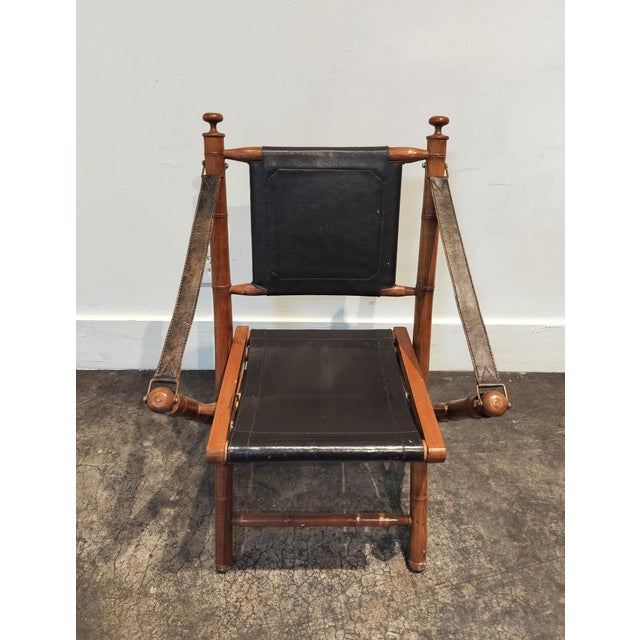 Charming solid teak and leather folding chair. Carved to resemble bamboo. Quality leather in dark brown. Measures 22"W ×...