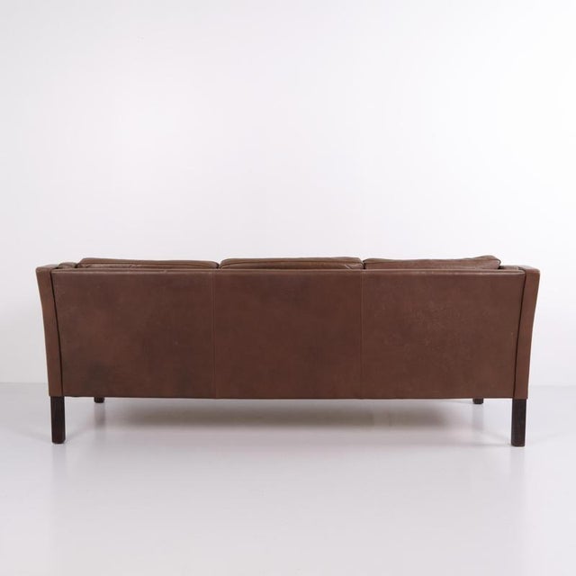 Three-seater sofa manufactured by stouby in the 1960s. The sofa is upholstered in brown leather and represents danish...