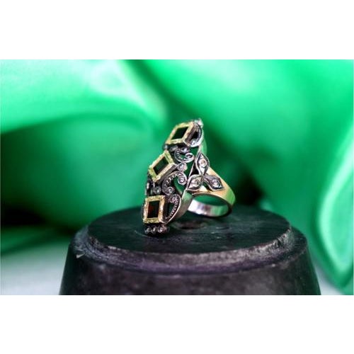 Gold and Silver Ring with Inlaid Diamond Chips and Calibrated Garnets, in Very Good conditions. Designed 1980 to 1989 This...