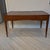 A striking French 1930s writing desk featuring an elegant, gently curved apron, tapered legs, and an inset leather writing...