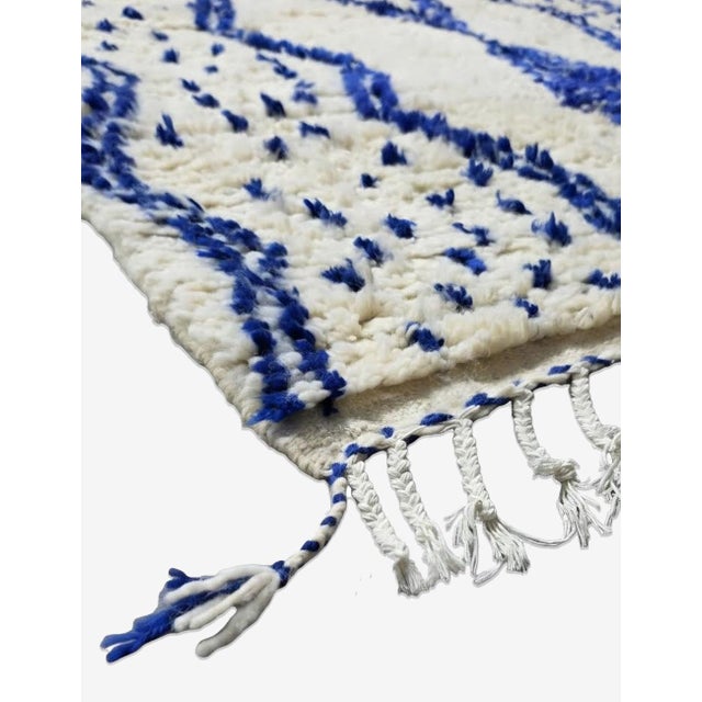Ivory and Blue Azilal Rug – Handmade Moroccan Berber Wool Rug This ivory and blue Azilal rug captures the beauty of...