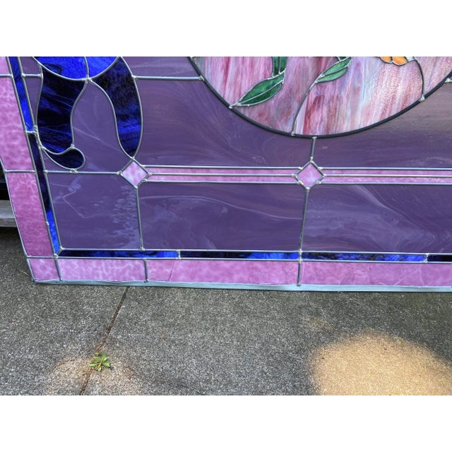 Original stain glass window. Done in very vibrant colors. The floral bouquet us beautiful purple, blue, yellow and the...