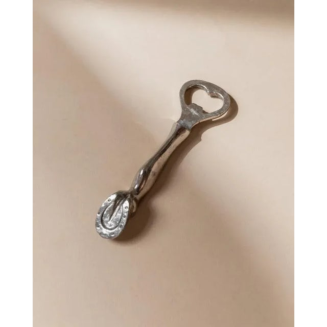 This rare vintage bottle opener from 1960s Italy is a refined example of Mid Century design. Silver plated and shaped like...