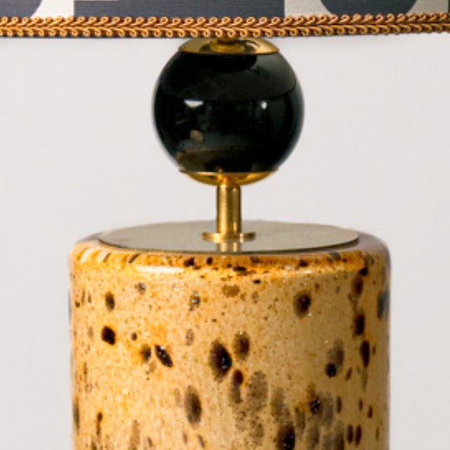 Pair of Murano glass table lamps, speckled in amber and black. These lamps have a striking, organic design, with a clear...