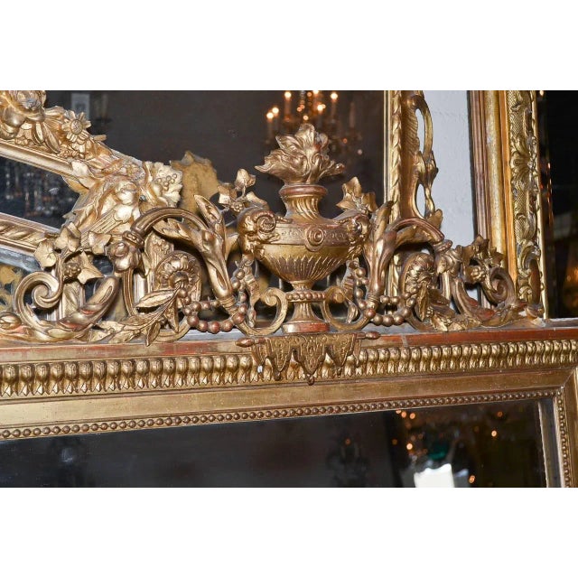 Fantastic 19th century French Louis XVI giltwood mirror. Having beautiful cartouche in foliate and urn motif, detailed...