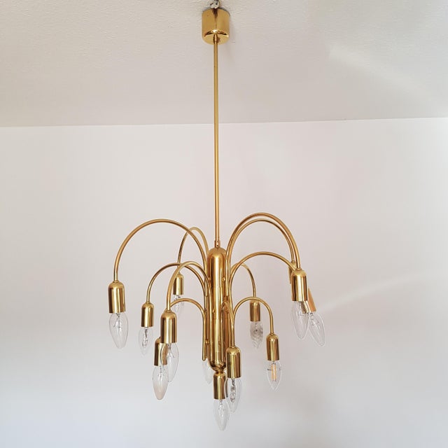 Mid-century 13-arm chandelier by "Sölken Leuchten" in Germany, from the 1970s. Exceptional light from the traditional...