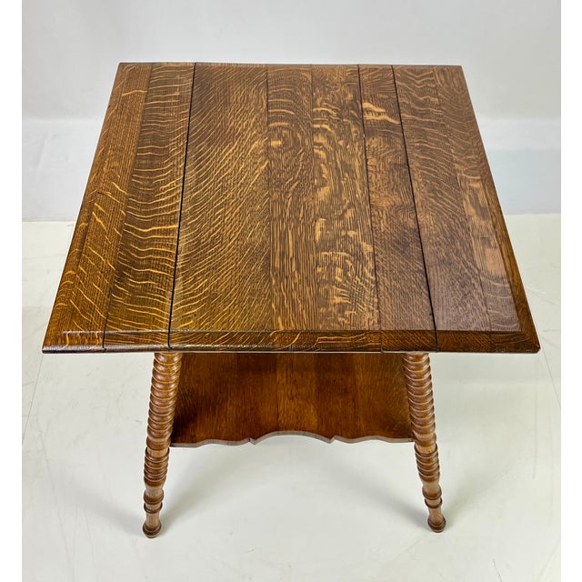 A classic late 19th- to early 20th-century American Victorian parlor table crafted from solid quarter-sawn "tiger" oak....