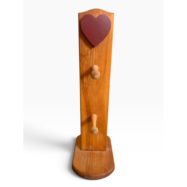 Charming vintage wooden mug holder by Gerald E. Henn Workshops of Warren, Ohio, featuring a distinctive sculptural...