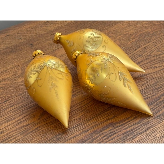 Three beautiful 1990s gold glass ornaments, hand painted. Most items found at Pub & Oasis are vintage and antique in...