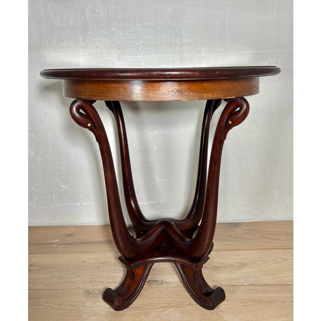 Elegant early 20th-century Art Nouveau side table crafted in solid oak with a beautifully sculptural pedestal base. The...