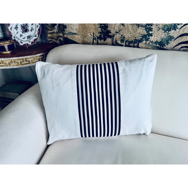 Single reversible cushion/pillow with navy blue striped fabric cut & pieced then set into the white fabric by hand. There...