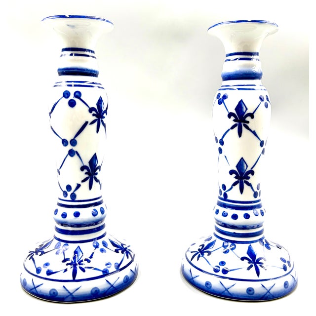 A lovely tall pair of vintage Delft style hand painted blue and white porcelain candlesticks from France. No maker's mark....