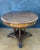 Spanish round table crafted in solid wood, dating to the early 20th century. The design reflects the historicist...