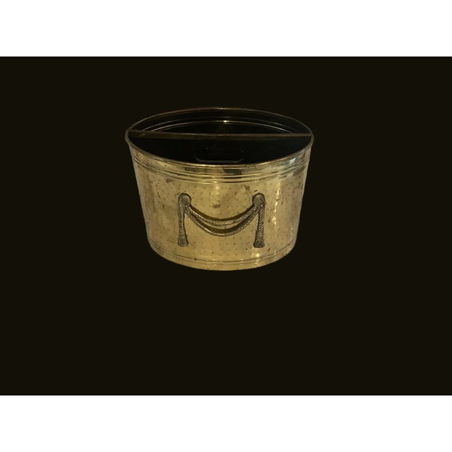 Mid century hammered solid brass magazine holder with rope and tassel motif. No makers mark. Some oxidation.