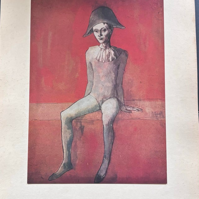 After Pablo Picasso, Seated Harlequjn Boy Against Red Background. A Limited First Edition, full-color original lithograph...