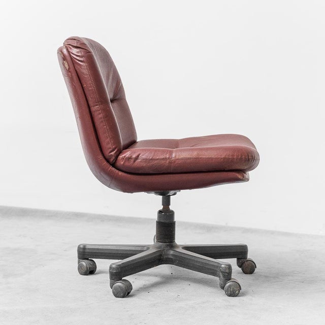 Office chair. Burgundy leather upholstery and plastic feet. Good condition, with signs of aging.